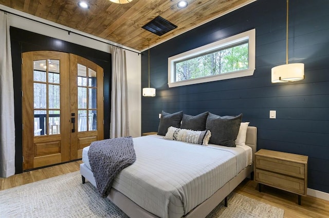 bedroom with wood ceiling and light hardwood / wood-style flooring