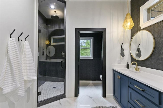 bathroom featuring vanity and a shower with door