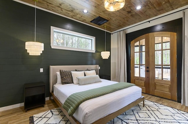 bedroom featuring french doors, access to exterior, light wood-type flooring, and wooden ceiling