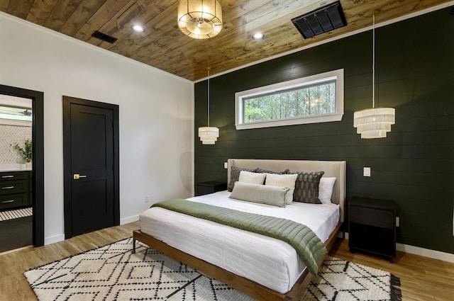 bedroom with wood ceiling and light hardwood / wood-style floors