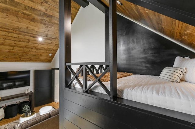 interior space with lofted ceiling, hardwood / wood-style floors, wooden ceiling, and wooden walls