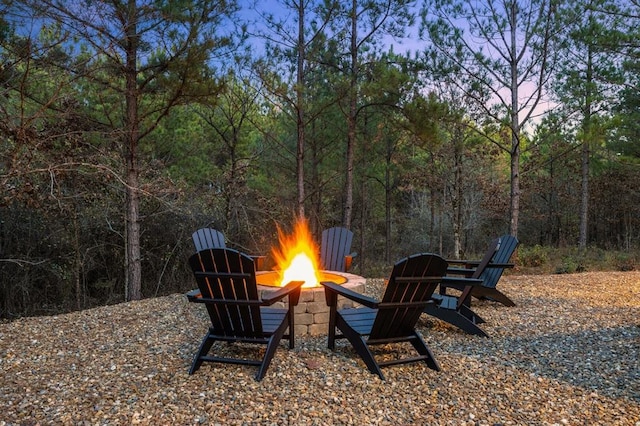 patio terrace at dusk featuring a fire pit