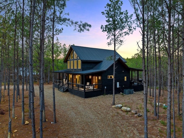 back house at dusk with covered porch