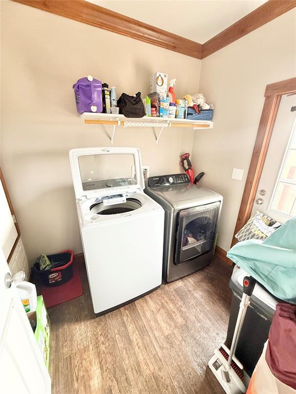 washroom with laundry area, independent washer and dryer, and wood finished floors