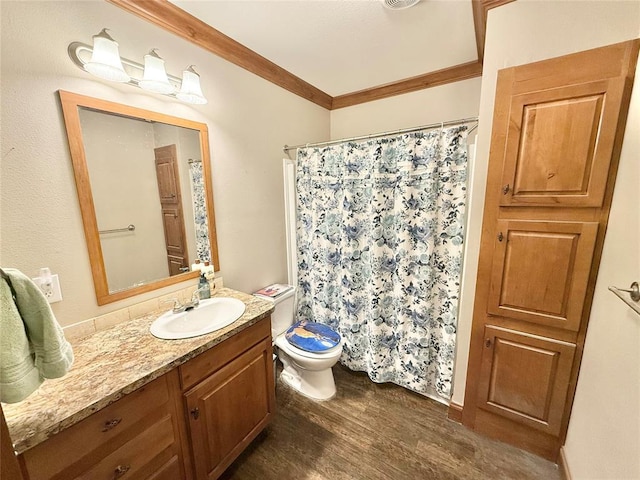 bathroom with toilet, wood finished floors, vanity, a shower with curtain, and crown molding