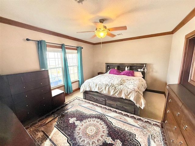 bedroom with carpet floors, ornamental molding, a ceiling fan, and baseboards