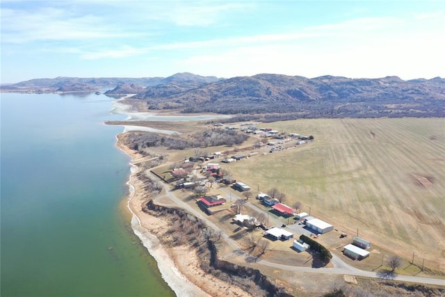 drone / aerial view featuring a water and mountain view