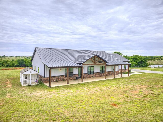 1632 County Road 1250, Tuttle, OK 73089 - view of front facade with a front yard, metal roof, and stone siding