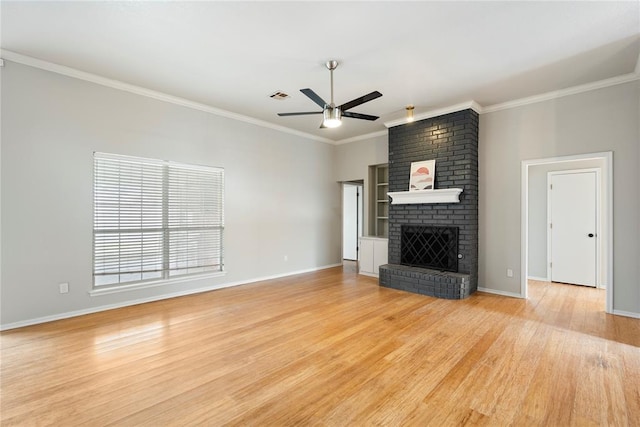 unfurnished living room with crown molding, light wood-type flooring, ceiling fan, and a fireplace