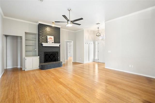 unfurnished living room with crown molding, a brick fireplace, ceiling fan, and light hardwood / wood-style floors