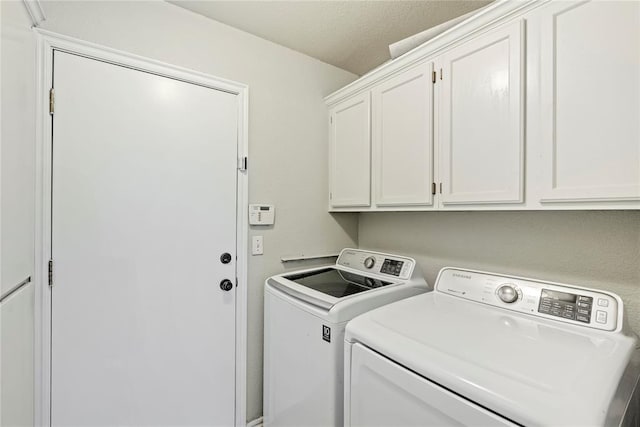 laundry area featuring cabinets and washer and clothes dryer