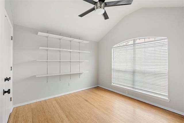 spare room featuring ceiling fan, vaulted ceiling, and light wood-type flooring