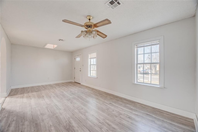 spare room with ceiling fan and light wood-type flooring