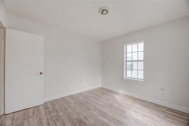 spare room with light hardwood / wood-style flooring