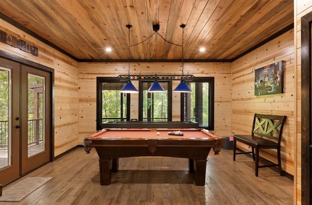 rec room featuring wooden walls, hardwood / wood-style floors, wood ceiling, and french doors