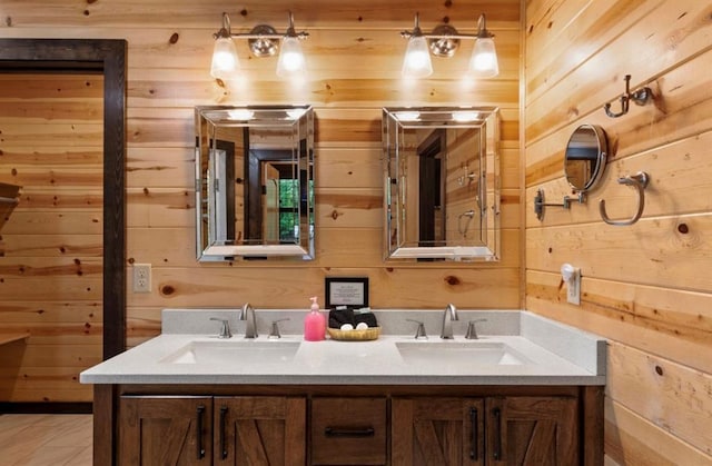 bathroom with vanity and wood walls