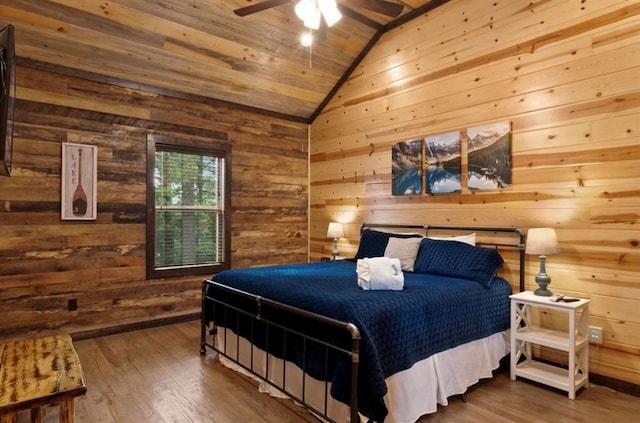 bedroom featuring hardwood / wood-style flooring, wood ceiling, wooden walls, and vaulted ceiling