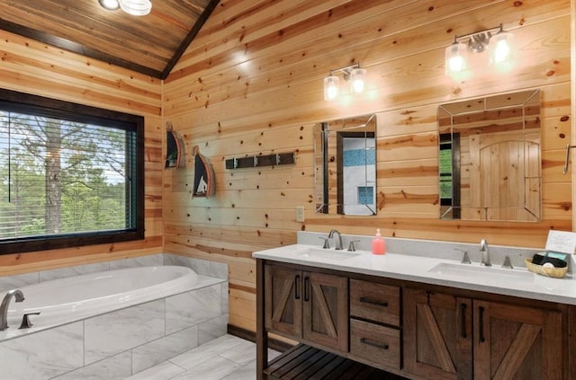 bathroom with tiled tub, vaulted ceiling, vanity, and wood walls