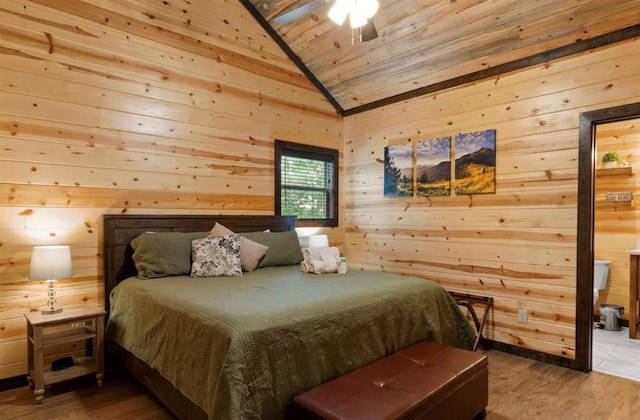 bedroom with wood-type flooring, wooden ceiling, ceiling fan, and wood walls