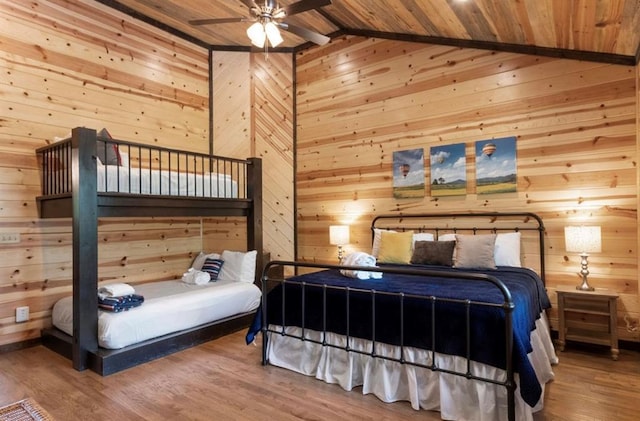 bedroom featuring wood ceiling, hardwood / wood-style flooring, and wood walls