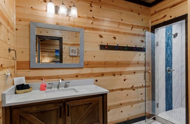 bathroom featuring walk in shower, vanity, and wood walls