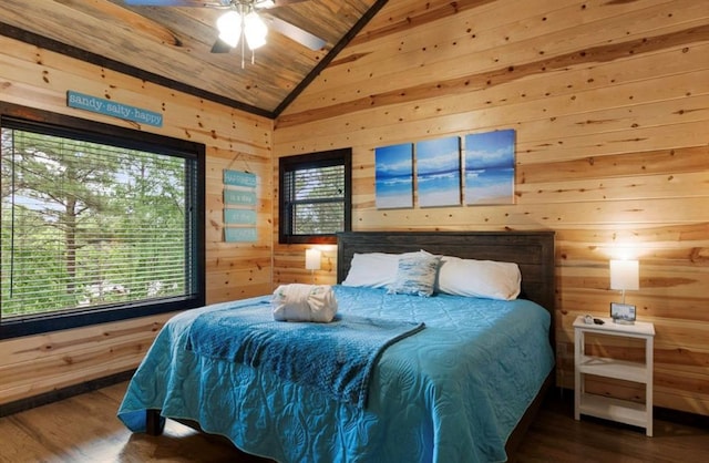 bedroom with lofted ceiling, multiple windows, and wooden walls