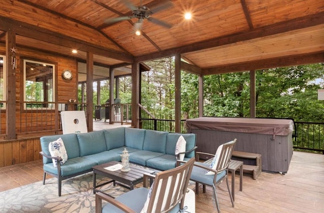 sunroom / solarium with lofted ceiling, wooden ceiling, and ceiling fan