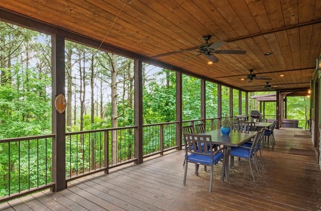 unfurnished sunroom with wood ceiling and ceiling fan