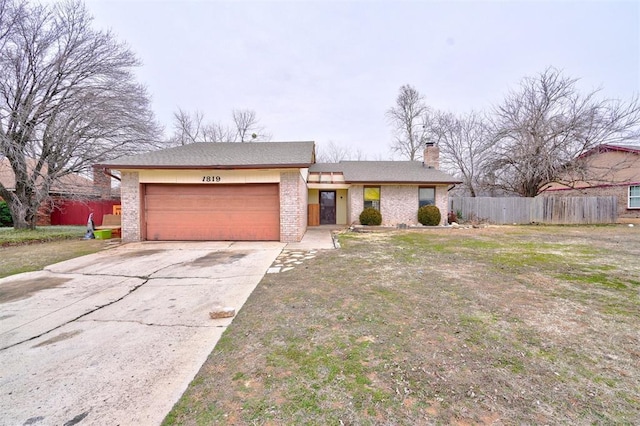 view of front of property featuring a garage and a front yard