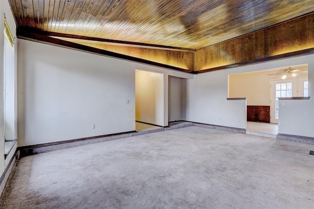 empty room with ceiling fan, lofted ceiling, light carpet, and wooden ceiling