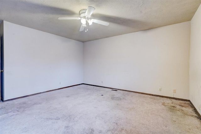 empty room featuring light carpet, a textured ceiling, and ceiling fan