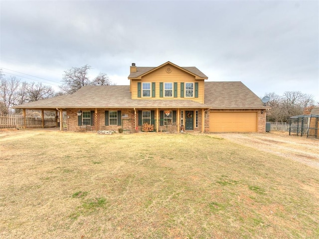 view of front of property featuring a garage, a porch, and a front yard