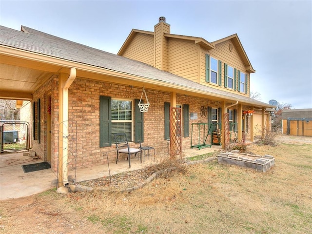 view of front of house featuring a porch and a patio