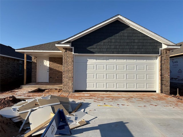 view of front of home featuring brick siding, concrete driveway, and an attached garage