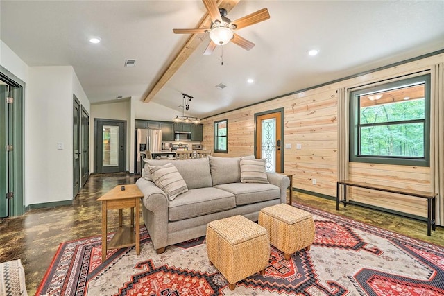 670 Pine Meadow Ln, Broken Bow, OK 74728 - living room with ceiling fan, wooden walls, concrete flooring, and lofted ceiling with beams
