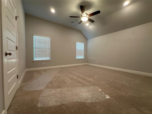 unfurnished room with lofted ceiling, carpet floors, and ceiling fan