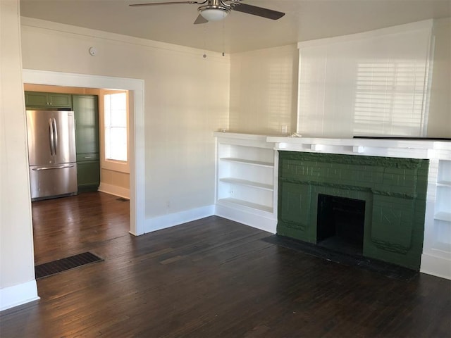 unfurnished living room featuring ceiling fan and dark hardwood / wood-style flooring