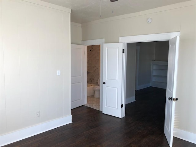 unfurnished bedroom with dark wood-type flooring