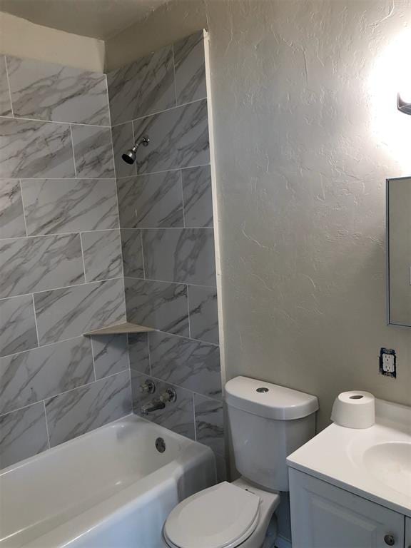 full bathroom with tiled shower / bath combo, vanity, and toilet