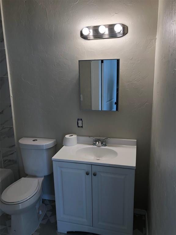 bathroom featuring vanity and toilet