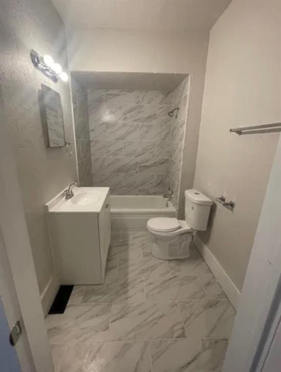 full bathroom with vanity, tiled shower / bath, and toilet