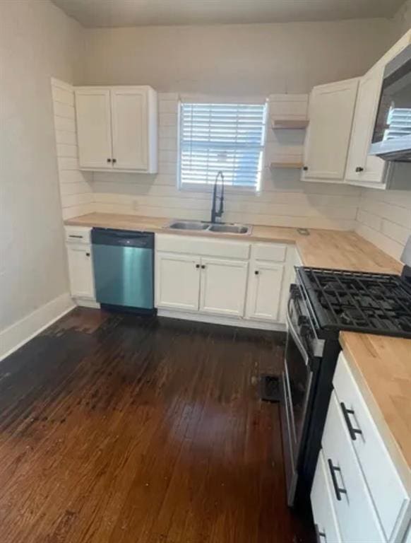 kitchen featuring butcher block counters, sink, white cabinetry, and appliances with stainless steel finishes