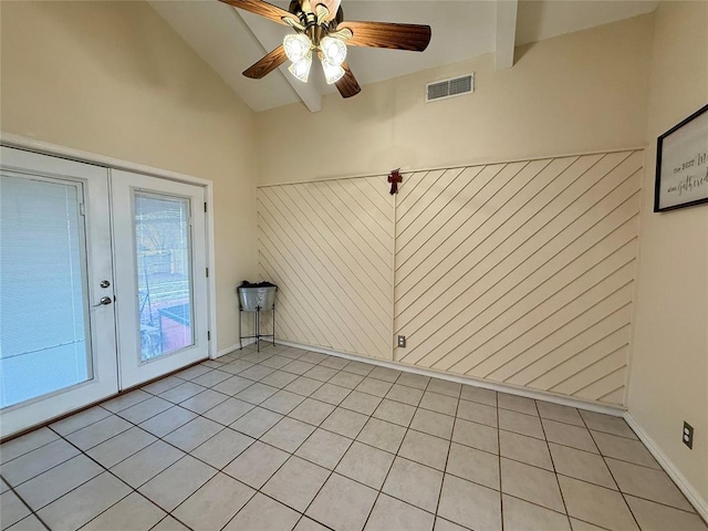 empty room featuring french doors, ceiling fan, and vaulted ceiling with beams