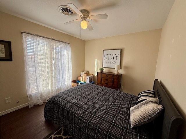 bedroom with ceiling fan and dark hardwood / wood-style floors