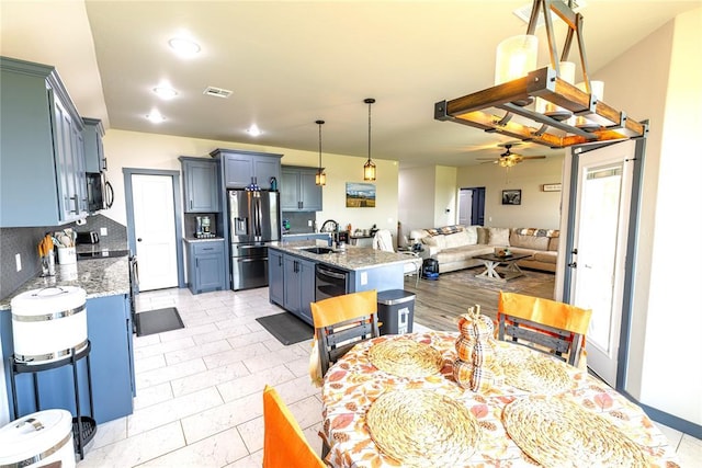 dining room featuring ceiling fan and sink