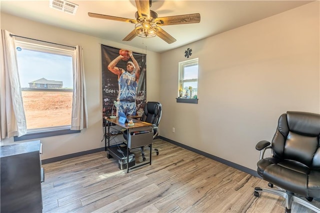 home office featuring ceiling fan and light hardwood / wood-style flooring