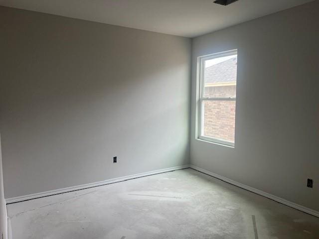 unfurnished room with concrete floors