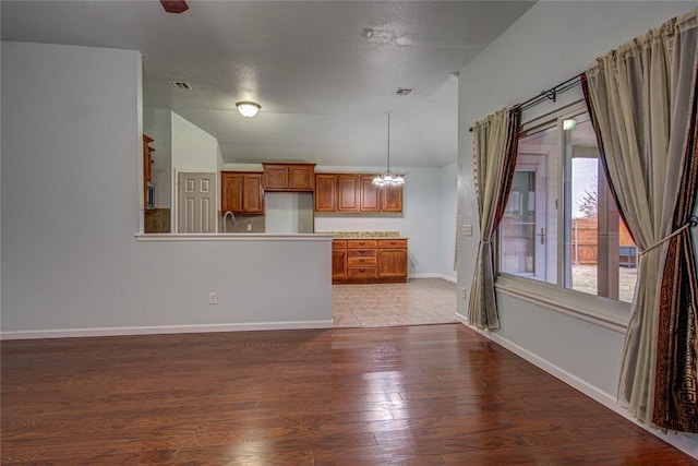 unfurnished living room featuring wood-type flooring and vaulted ceiling