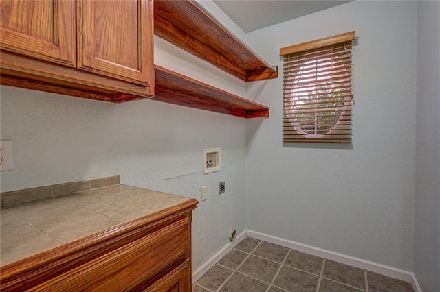 laundry area with electric dryer hookup, hookup for a washing machine, and cabinets