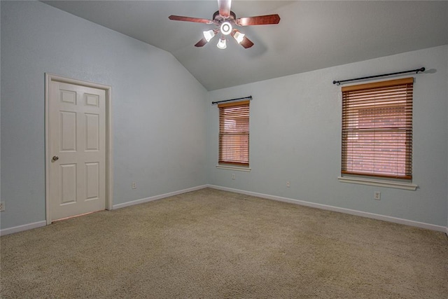 carpeted spare room with lofted ceiling and ceiling fan